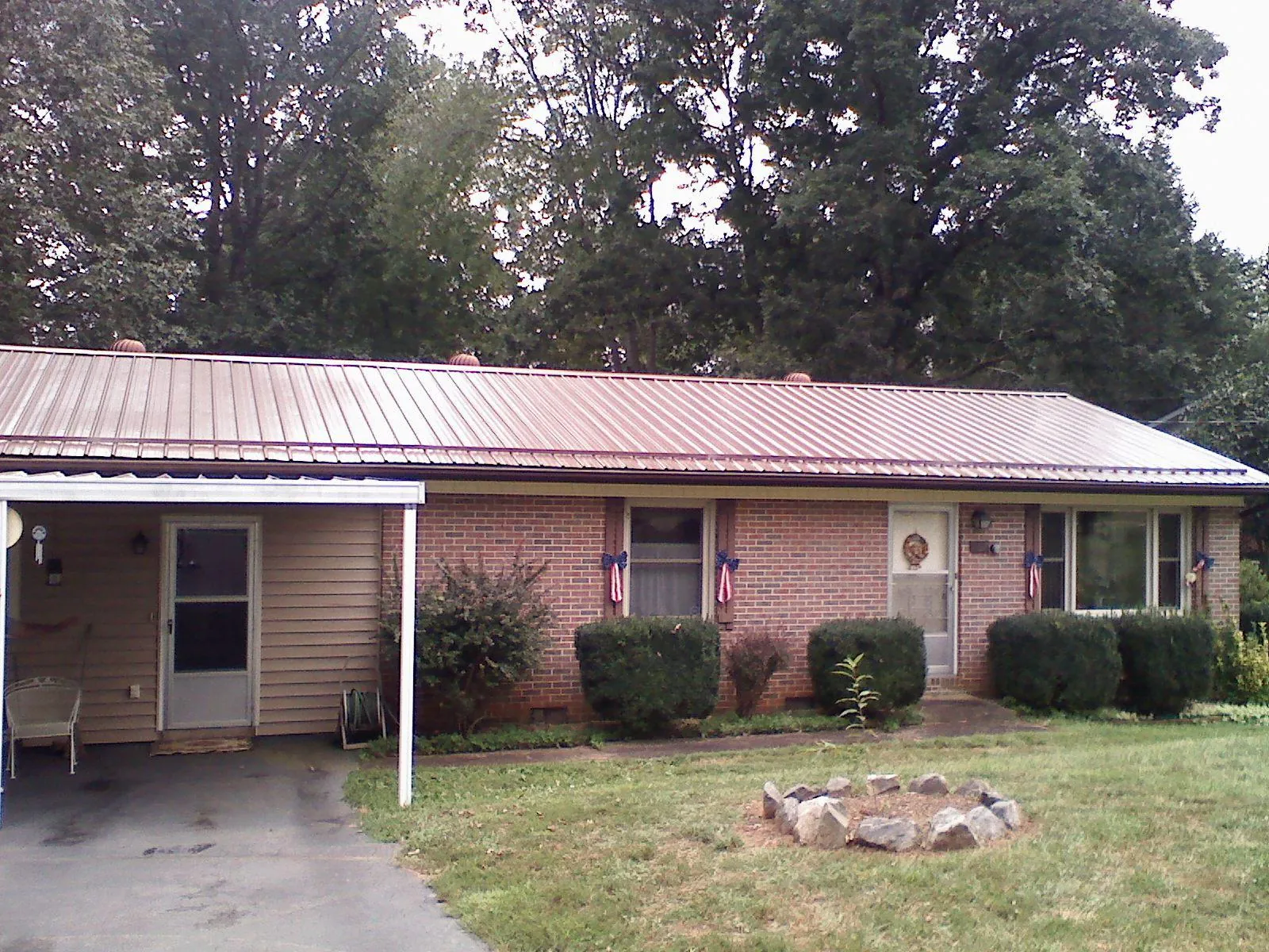 Bronze metal roof and carport on a brick ranch home — Roof Repair work by our crew in Sacramento